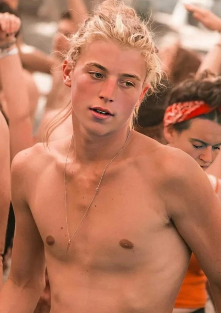 Young man at an outdoor gathering, photograph preserved on a memorial page