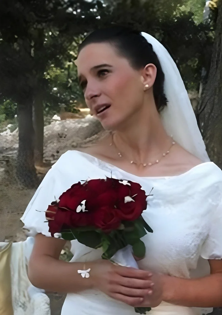 Woman in wedding dress holding roses, photograph preserved in remembrance