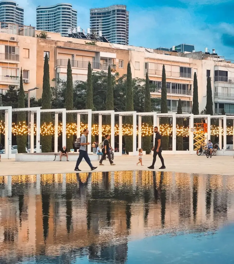 The Light Monument at Habima Square at night, with rows of warm memorial bulbs honouring lives lost on 7 October 2023