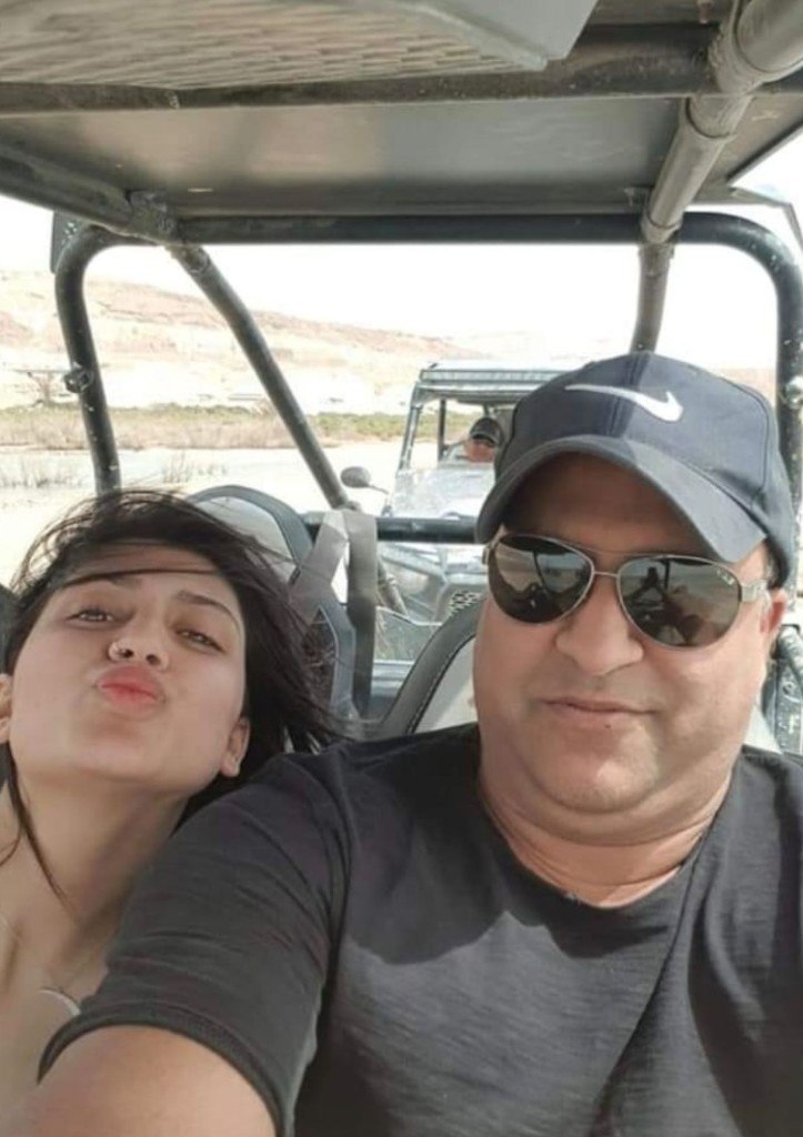 Kim and a man sharing a happy moment in an open desert off-road vehicle
