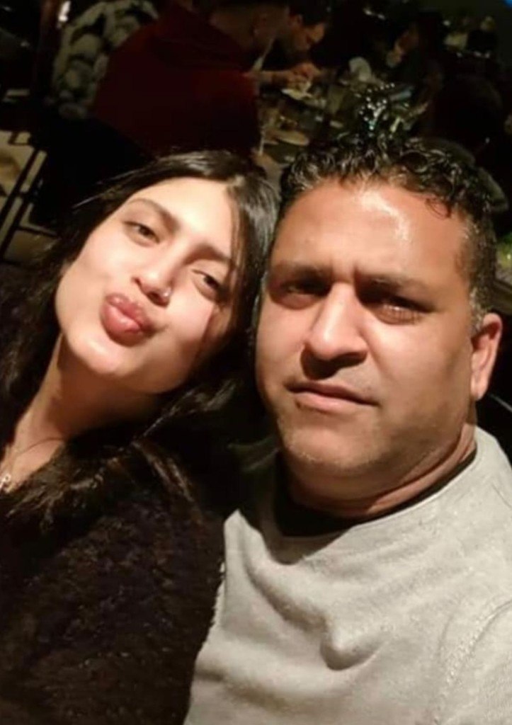 A warm close-up selfie of Kim and a man leaning together at a restaurant